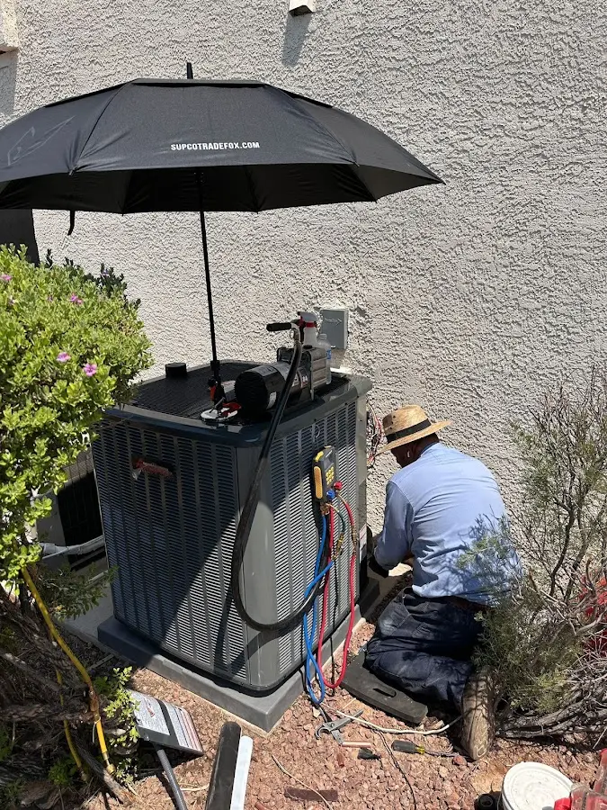 HVAC technician performing outdoor AC maintenance in Prichard